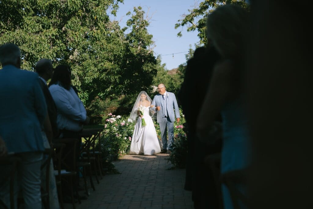 Bride walks down the aisle at Walnut Grove