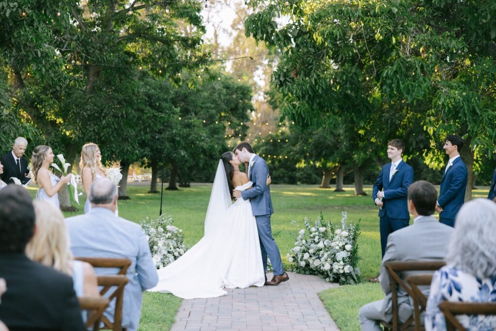 Bride and groom first kiss at Walnut Grove